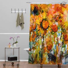 a shower curtain with an abstract painting on it in a bathroom next to a bathtub