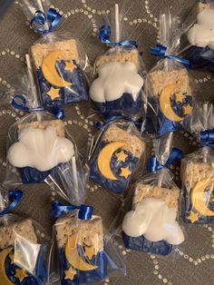 some cookies are wrapped in plastic and have blue ribbon around the edges with white frosting on them