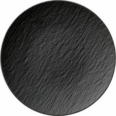 a round black slate plate on a white background