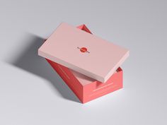 an open pink box with a red apple on the front and bottom, sitting on top of a gray surface