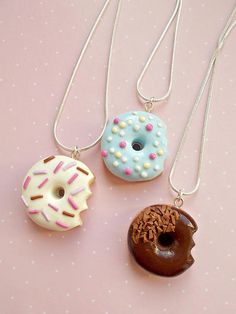 three different types of donuts on a pink surface