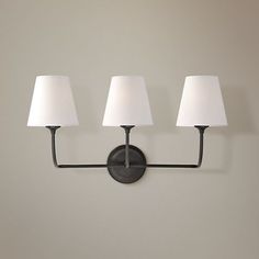 three lamps mounted on the wall in a room