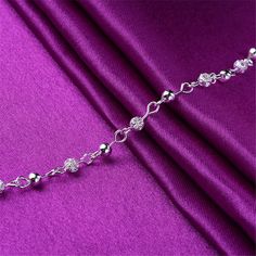 Show off your pedicure and add touch of light-catching shine to your ensemble with this elegant anklet plated in gleaming sterling silver. 0.27'' W x 9.84'' L S-hook clasp Fine silver-plated copper