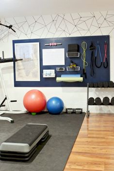 a gym with exercise balls and equipment on the floor