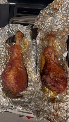 two pieces of meat sitting on tin foil