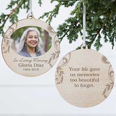 an ornament hanging from a christmas tree with a memorial photo on the front