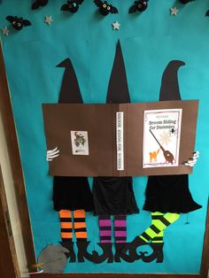 a bulletin board decorated with witches and brooms