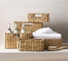 three wicker baskets with towels and toothbrushes