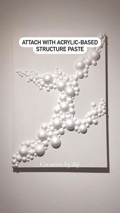 a poster with white balls on it and the words attach with acrylic - based structure pastee