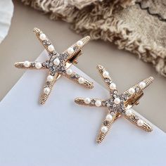 What can be more appropriate for a relaxed beach wedding than these starfish hair clips! They can be the perfect addition to your hair style, or a hair accessory for your Bridesmaids or Flower Girls to match your wedding theme and the vibe of the sea. Adorned with glowing pearls crystals on a gold / silver base, the design coordinates with any hair style and any color wedding dress. The sturdy clip mechanism on the back will attach to your hair and keep it securely in place. The sea star measure Summer Beach Hair, Seashell Hair, Starfish Hair Clip, Stone Cold Fox, Jennifer Behr, Bridal Hair Clip, Cheap Hair Products, Flower Hair Pin, Hair Clips Girls