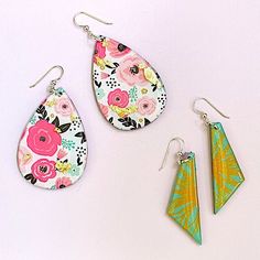 three pairs of earrings with floral designs on them, one is green and the other is pink