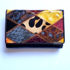 Multicolored Animal Print Wallet Brand New Never Used With Box Made With Quilted Patchwork In Yellow, Burgundy, Black, Brown In Different Types Of Animal Print! Beautiful Stitching Between Each Section Genuine Leather Beautiful Unique Wallet You Wont' Find Anywhere Else And Makes A Great Gift! Wallet Measures Approx 4.75" Width X 3.25' Length X 1" Depth Interior Includes Large Pocket For Bills That Has A Hidden Zipper Inside For Extra Security 6 Interior Card Slots With Button Enclosure Other Si Multicolor Leather Wallet For Everyday Use, Multicolor Leather Wallets For Everyday Use, Trendy Rectangular Leather Wallets, Trendy Leather Wallet, Rectangular Shape, Trendy Leather Rectangular Wallets, Multicolor Leather Rectangular Wallet, Multicolor Leather Wallets For Daily Use, Multicolor Leather Wallets, Trendy Multicolor Wallets For Gifts