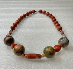 Vintage necklace made of opaque stone of mottled salmon pink and green, sometimes called red jasper and unikite. It has a Mohs scale hardness of 6 to 7 with a  mixture of pink feldspar, green epidote.  Unikite is named after Unaka mountain range in Tennessee where it was discovered in 1874. Thereafter, mined in South Africa. Also includes 18 red carnelian 8mm beads. Size 25" Long. Red Jasper Spiritual Necklace, Artisan Red Jasper Necklaces, Unique Red Jasper Necklaces, Unique Multicolor Jasper Necklaces, Red Jasper Necklaces, Red Carnelian, Mohs Scale, 8mm Beads, Salmon Pink