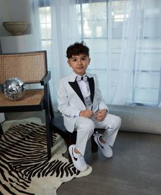 5 Piece Fashion Sequin Tuxedo Set dapper your little gentleman right up! This look is smoother than sequins with its glitter finish.  Talk about wanting to be the star of the occasion, or even just a little bling bling. Boy's 5-Piece Fashion Sequin Tuxedo Set consists of a high quality jacket, a double breasted vest, pants, shirt and bowtie.  Peak Lapel Jacket offers side vents for ventilation and comfort. Comes with matching pants. Pants need to be hemmed/tailored to match his height.  Modern Sequin Tuxedo Set is European Cut which makes it really slim, so please keep allowances in mind. Whatever the occasion, may it be a part, a wedding, or even just another day out and about- we are here for the moments for that matter! Fitted White Three-piece Suit For Party, White Fitted Three-piece Suit For Party, White Fitted Three-piece Party Suit, Tailored Tuxedo Party Sets, White Three-piece Suit For Party, White Tuxedo Three-piece Suit For Party, White Tuxedo Set For Party, White Tuxedo Style Party Set, White Tuxedo Party Set