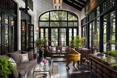 a living room filled with furniture and lots of windows