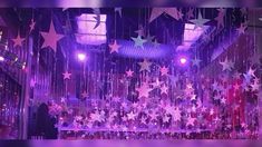 a stage with stars hanging from the ceiling