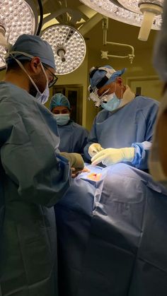 three surgeons performing surgery in an operating room