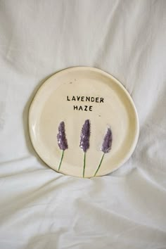 a plate with lavender flowers on it that says lavender haze