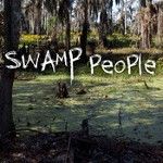 the words swamp people are in front of some trees