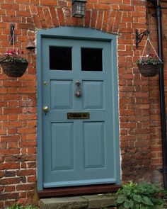 a blue front door on a brick building