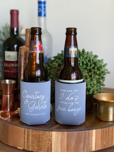 two beer bottles sitting on top of a wooden table