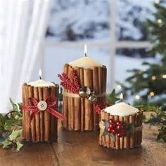 three candles made out of sticks and cinnamons