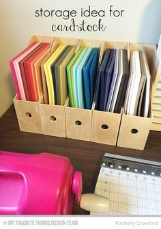 there are many different colored folders in the holder on the desk next to each other