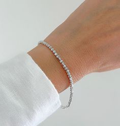 "Shiny And Bright 14K White Gold Moon Cut Ball Bead Bracelet. Diamond Cut Beads That Are Perfect For Layering Or Worn Alone. The Perfect Gift To Give. Jewelry Comes In A Cute Gift Box Ready To Present.  ▪️All Jewelry Is New And Inspected For Quality Assurance.  ▪️Jewelry Is Crafted In Genuine High Quality 14K Gold. ▪️We Do Not Sell Gold Plated.  Product Detail: Metal: 14K White Gold Width: 2.5MM Length: 7\" Inch Closure: Lobster Claw Weight: 3.4 Grams ✨ Feel free To Ask Me Any Questions Or Concerns You May Have ✨ 🌈 Follow Me On Instagram @sarakayjewelry Thank You For Visiting My Shop." Everyday Single Strand Beaded Bracelets, Minimalist Round Bracelet With Faceted Beads, Minimalist Single Strand Beaded Bracelets With Round Beads, Everyday Silver Single Strand Bracelet, Everyday Single Strand Bracelet With Round Beads, Silver Single Strand Bracelet For Everyday, Adjustable Beaded Bracelets With Sparkling Stones, Minimalist Single Strand Beaded Bracelet, Elegant Single Strand Beaded Bracelets