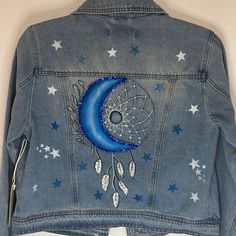 a denim jacket with stars and a moon on it