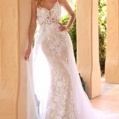 a woman in a wedding dress posing for the camera