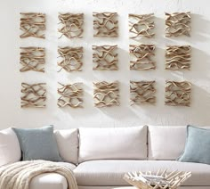 a living room filled with furniture and lots of wood pieces on the wall above it