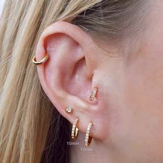 a woman's ear is shown with three different types of piercings