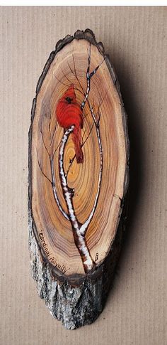 a piece of wood with a red bird on it