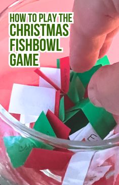 someone is playing the christmas fishbowl game with their hands and paper pieces in it