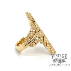 A Vintage and Jewelers original design, this 18k gold ring has two leaf branches bypassing each other. The leaves have a sparkling stippled texture with hand engraved bright cut veins. Twelve natural round, VS clarity, G/H color diamonds are flush set throughout the ring for a total diamond weight of .25 carats. The ring length measures 34 mm from leaf tip to leaf tip and is currently a finger size 7. A very flattering style, it sits low and flat and lengthens the finger by drawing the eye down. Bypass Ring, Leaf Motif, 18k Gold Ring, G H, Hand Engraving, Ring Holder, Rose Gold Ring, Original Design, Gold Ring