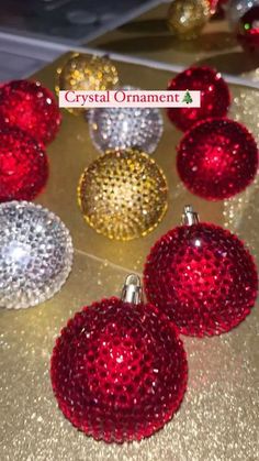 six red and silver ornaments on a gold counter top with the words crystal ornament