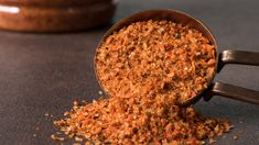 a scoop full of ground spices sitting on top of a table