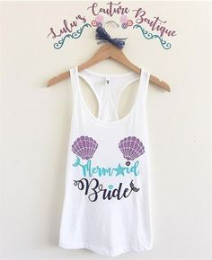 a white tank top with the words mermaid bride on it hanging from a hanger