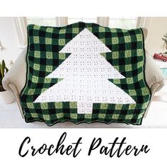 a green and white christmas tree quilt on a couch