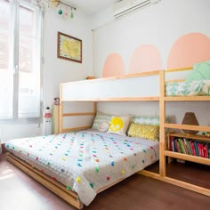 a child's bedroom with a bunk bed and bookshelf in the corner