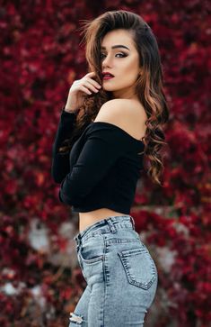 a beautiful woman in jeans posing for the camera