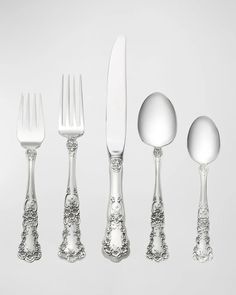 an assortment of silverware including forks, knives and spoons on a white background