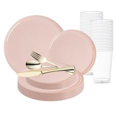 a set of pink plates with gold forks and spoons next to a stack of clear cups