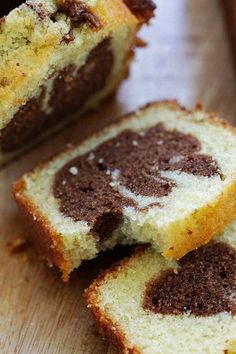 two pieces of cake sitting on top of a wooden cutting board