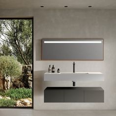 a bathroom with a sink, mirror and large sliding glass door leading to the outside