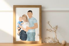 a man and woman holding a baby in front of a framed photo on a table