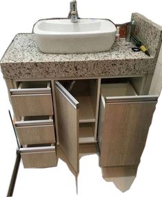 a white sink sitting on top of a wooden cabinet next to a counter with drawers