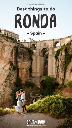 two people standing in front of a bridge with the words best things to do ronda spain