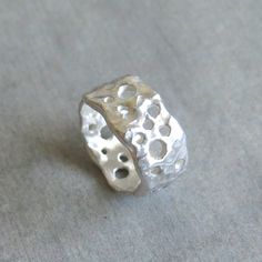 "This delicate organic shaped ring/ band is fully handmade of solid sterling silver with randomly arranged holes of different sizes. The irregular molten texture catches the light and sparkles. The model of each ring is carefully handmade of wax and cast in my home studio's foundry. The ring is elegant, not too chunky on the finger and very comfortable to wear. It is a sturdy, lasting piece of jewelry.  This gorgeous ring ring is ideal for everyday wear and it will also look amazing with a festi Wax Silver Jewelry, Silver Ring Chunky, Silver Handmade Ring, Art Clay Silver Ring, Organic Silver Jewellery, Silver Clay Ring Ideas, Silver Ring Handmade, Chunky Silver Jewelry, Ring Designs Silver