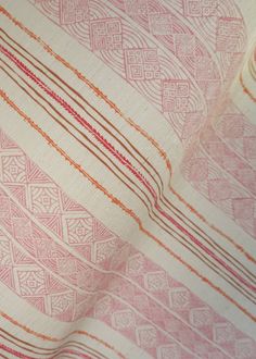 an orange and white striped fabric with red lines